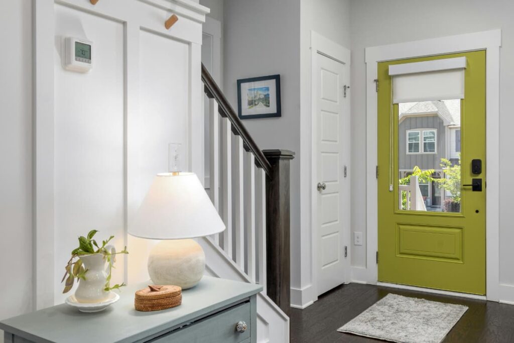 Clean, well-lit home entryway with a keypad door lock and simple organization